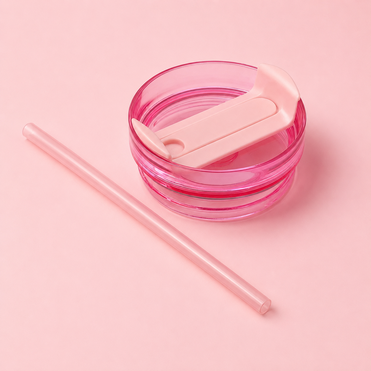Pink container with a straw on a pink background
