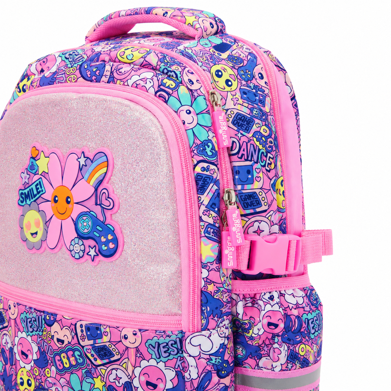 A pink backpack with a glittery front pocket featuring a large smiling flower patch, covered in a colorful cartoon pattern with text like 'DANCE', 'YES!', and 'SMILE!'.