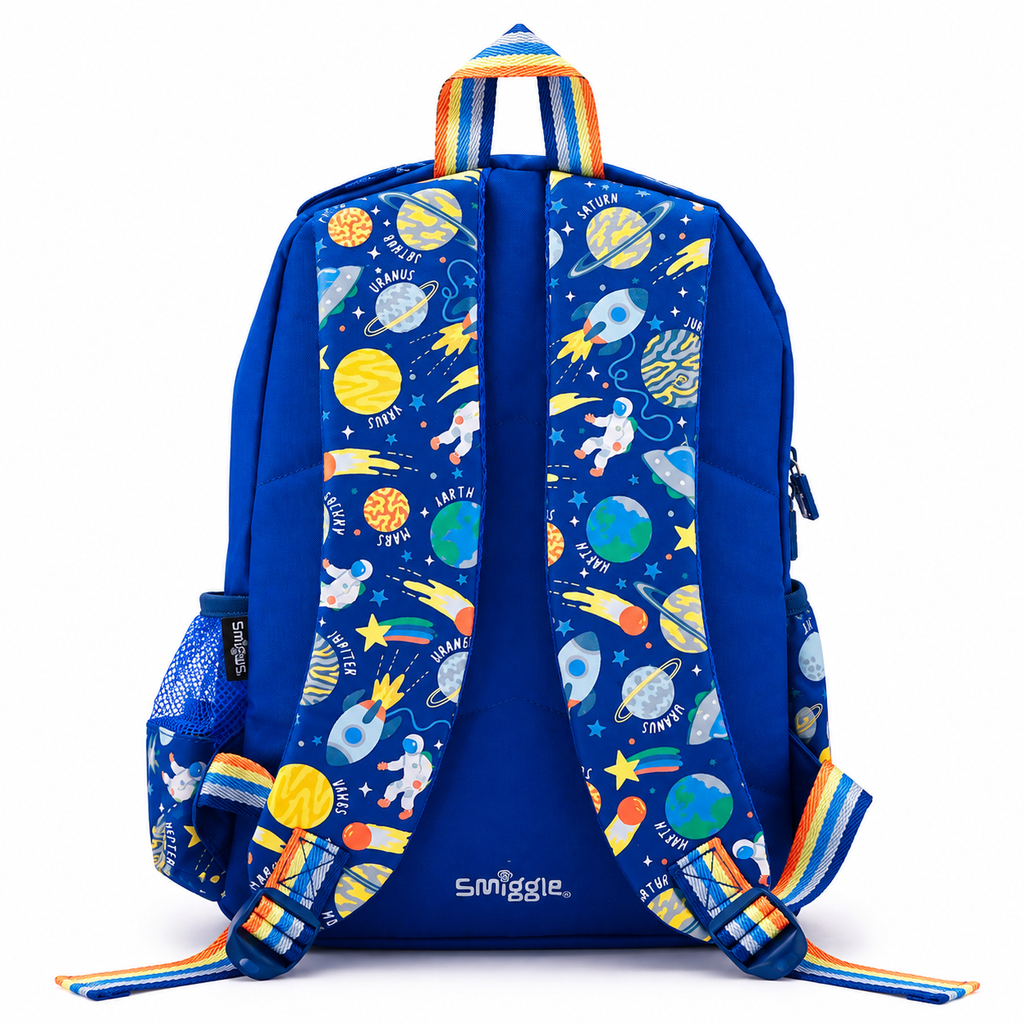 A blue backpack shown from the back, featuring a colorful space-themed print with astronauts, planets, rockets, and stars on the padded shoulder straps and side mesh pockets. The brand name 'Smiggle' is printed in white near the bottom center.