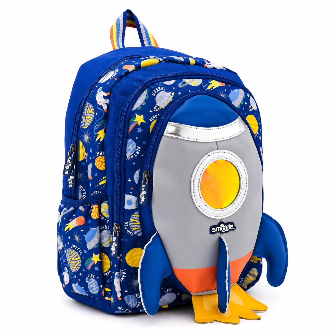 A blue backpack featuring a playful outer-space print on the sides and a large plush rocket-shaped front pocket with a gray body, yellow circular window, orange nose, and yellow feet. The brand name 'Safaril' is visible on the front pocket.